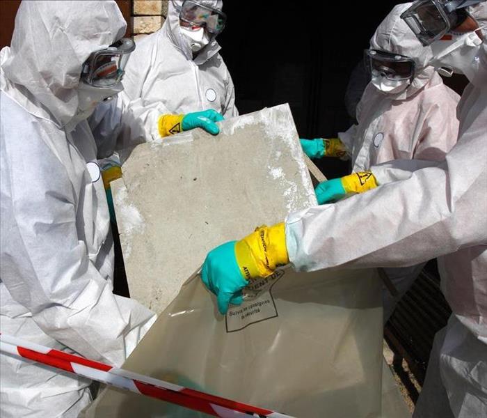asbestos abatement team disposing of questionable materials
